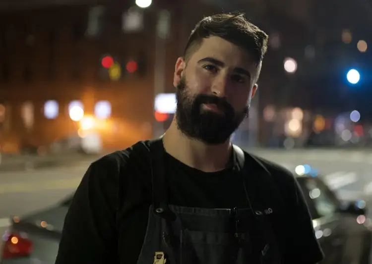 Bartender Kyton Blair stands on a Seattle street.