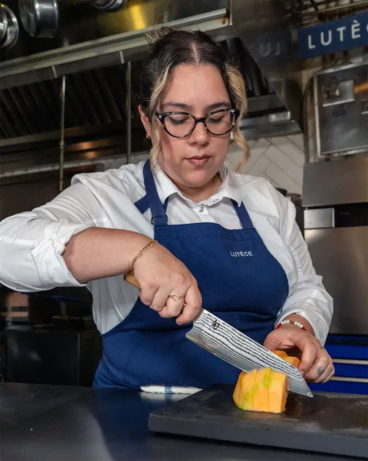 Chef Ana Sofia Pino cuts a cantaloupe with a Shun Classic Blonde Kiritsuke knife