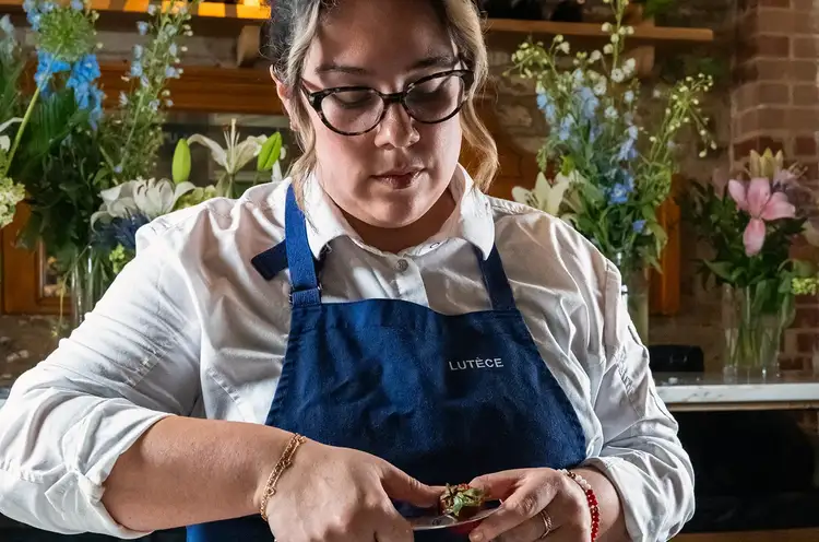 Chef Ana Sofia Pino Looking Down while Cutting a Strawberry with a Shun Classic Bird's Beak Knife