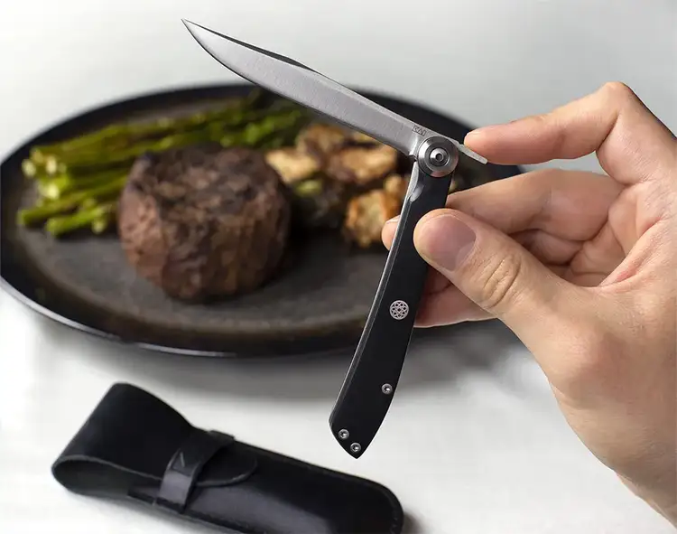 Close up of a hand opening a Personal Steak Knife.